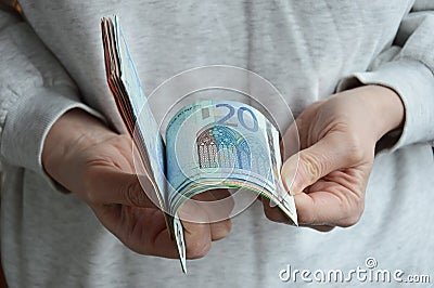 Moscow, Russia, 03/27/2022, a woman counts banknotes with her hands. European money, euro. Editorial Stock Photo