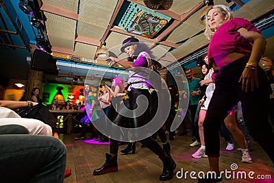 MOSCOW, RUSSIAN FEDERATION - OCTOBER 13, 2018: Cuban dance teachers conduct a master class in salsa and reggaeton in the night clu Editorial Stock Photo