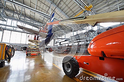 Repair of tail of passenger aircraft Aeroflot in hangar Editorial Stock Photo