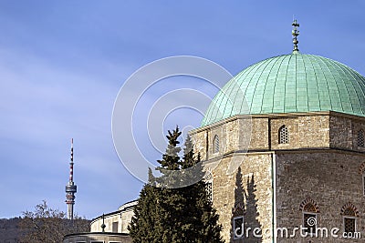 The mosque of pasha Qasim the Victorious with the TV Tower in the background in Pecs Stock Photo