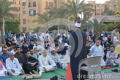 A mosque preacher Imam performs Eid Al Fetr Khutbah (sermon) in an open air space near the mosque, Editorial Stock Photo