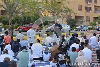 A mosque preacher Imam performs Eid Al Fetr Khutbah (sermon) in an open air space near the mosque, Editorial Stock Photo