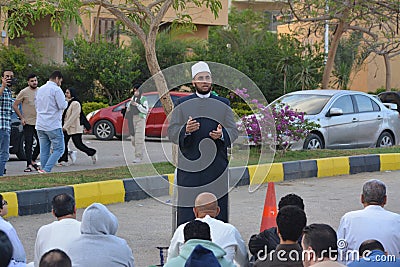 A mosque preacher Imam performs Eid Al Fetr Khutbah (sermon) in an open air space near the mosque, Editorial Stock Photo