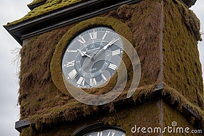 Moss growing on the face of a clock tower Stock Photo