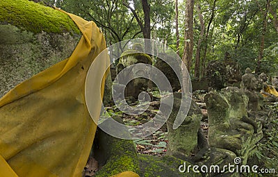 Moss on old Buddha statue in the forest Stock Photo