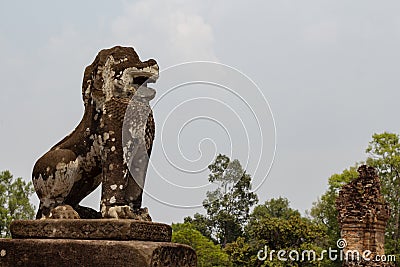 Mossy stone lion statue, Angkor Wat complex, Cambodia. Ancient temple in Siem Reap. Stock Photo