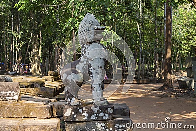 Mossy stone lion statue, Angkor Wat temple complex, Cambodia. Spiritual protector Barong. Ancient temple in Siem Reap. Stock Photo