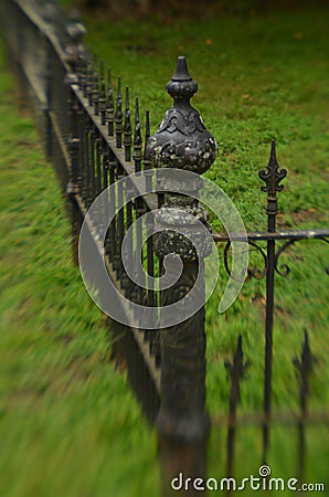 Mossy weathered vintage iron fence Stock Photo