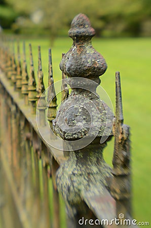 Mossy weathered vintage iron fence Stock Photo