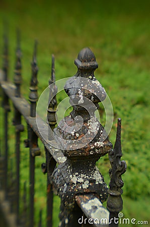 Mossy weathered vintage iron fence Stock Photo