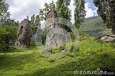 The greenery of the Garden of Ninfa and ruins of the medieval city Ninfa in Italy in the province of Latina. Editorial Stock Photo