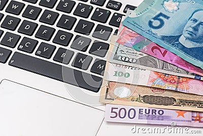 Most world paper money with laptop Stock Photo