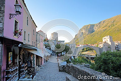 The main commercial pedestrian and cobbled street with shops for tourists and with the Old Bridge Stari Most Editorial Stock Photo