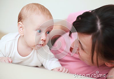 Mother adore her cute baby on bed Stock Photo