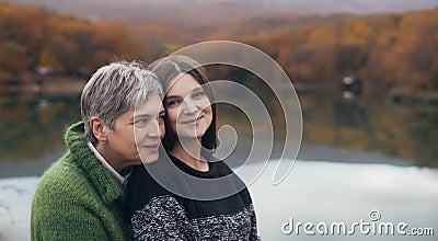 Mother and adult daughter on autumn background Stock Photo