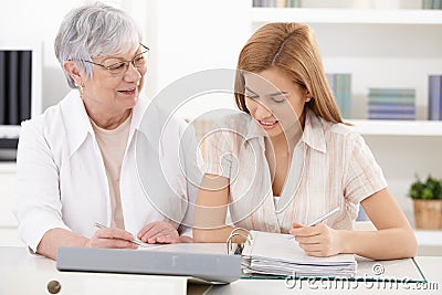 Mother and adult daughter doing paperwork Stock Photo