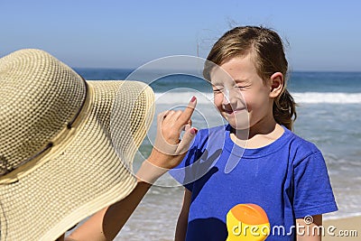 Mother applying sunscreen Stock Photo