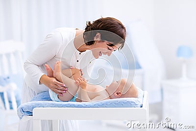 Mother and baby on changing table Stock Photo