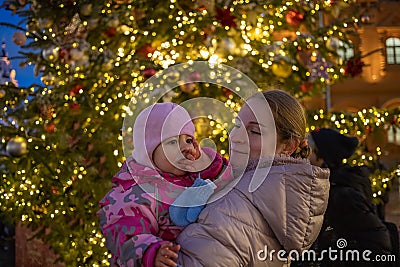 Mother and baby on christmas backgrouund street outdoors Stock Photo