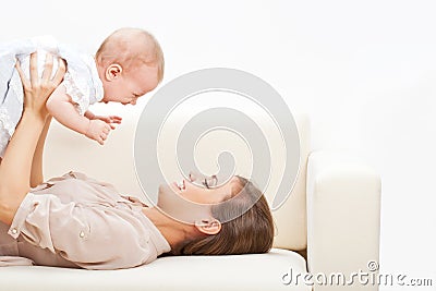 Mother and baby laying on sofa Stock Photo