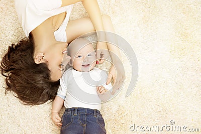 Mother and Baby lying on Carpet, Happy Family Portrait, Kid Boy Stock Photo