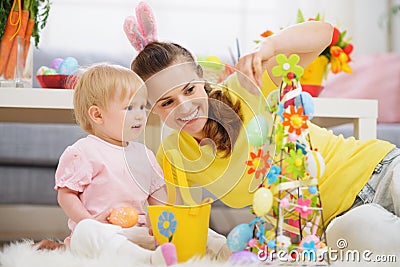 Mother and baby making Easter decoration Stock Photo