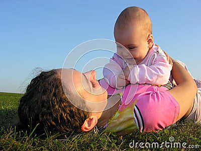 Mother with baby on sunset lie Stock Photo