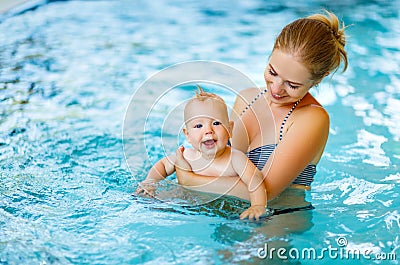 Mother and baby swim in pool Stock Photo