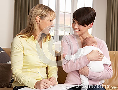 Mother With Baby Talking With Health Visitor Stock Photo