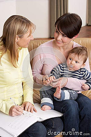 Mother With Baby Talking With Health Visitor Stock Photo