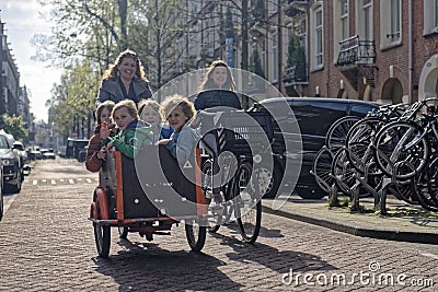 Mother and kids riding bicycle in Amsterdam Editorial Stock Photo