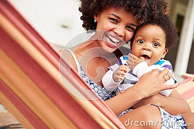 Mother bonding with young son sitting in a hammock, portrait Stock Photo