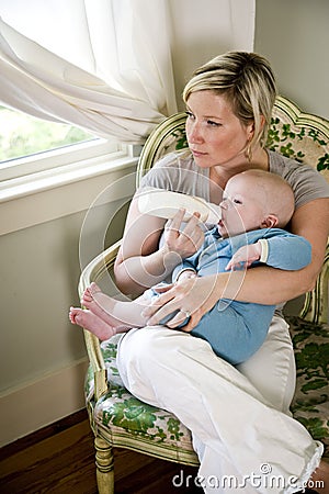 Mother bottle-feeding her seven month old baby Stock Photo