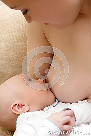 Mother breast feeding her little son Stock Photo