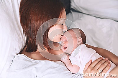 Mother breastfeeding newborn baby at home. Stock Photo