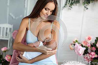 Mother breastfeeding her newborn child Stock Photo