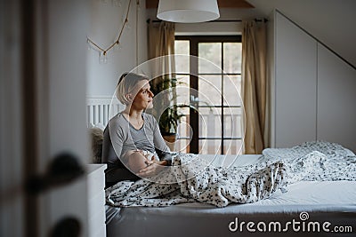 Mother brestfeeding her little newborn baby in their bedrooom. Stock Photo