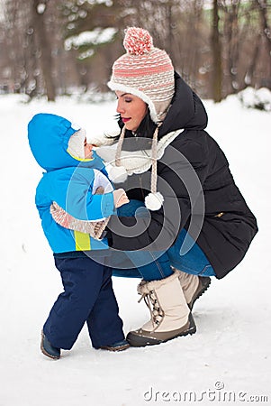 Mother caring her baby boy in winter Stock Photo