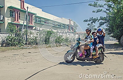 A mother is carrying her chidren on the bike Editorial Stock Photo