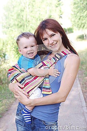 Mother carrys son in baby sling Stock Photo