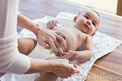 Mother changing baby diaper Stock Photo