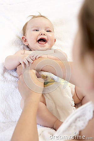 Mother Changing Baby Nappy Stock Photo