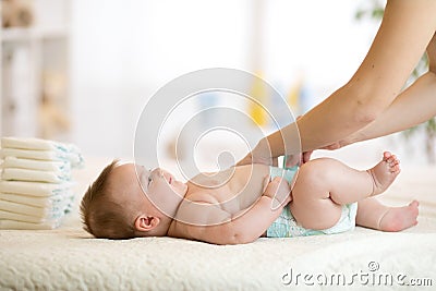 Mother changing the baby`s nappy Stock Photo