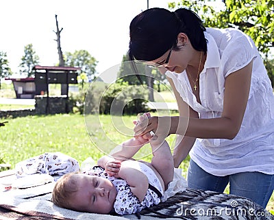 Mother changing diaper Stock Photo