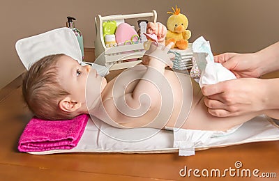 Mother changing diaper of adorable baby Stock Photo