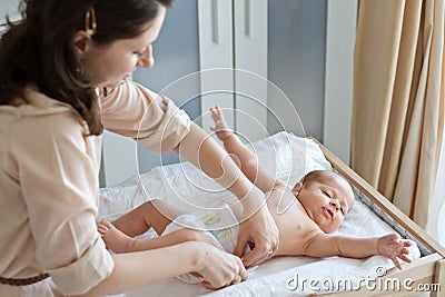 Mother changing diapers Stock Photo