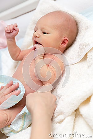 Mother changing diapers for their newborn baby Stock Photo