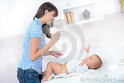 Mother changing babys diaper Stock Photo