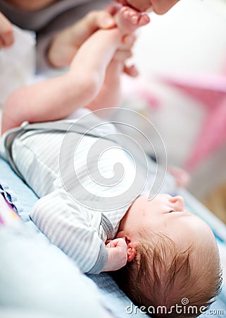 Mother changing a newborn baby's diaper Stock Photo