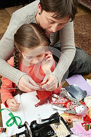 Mother and child girl knit, handmade and handicraft concept Stock Photo